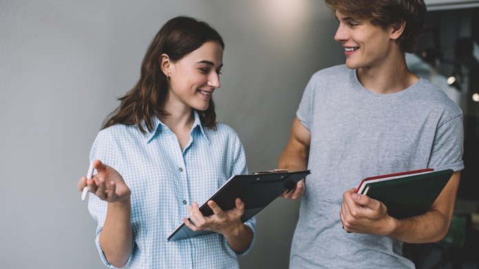 Young people talking, holding tablets
