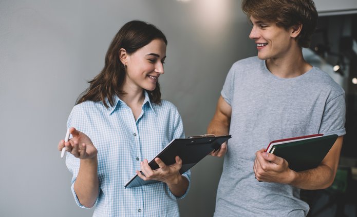 Young people talking, holding tablets