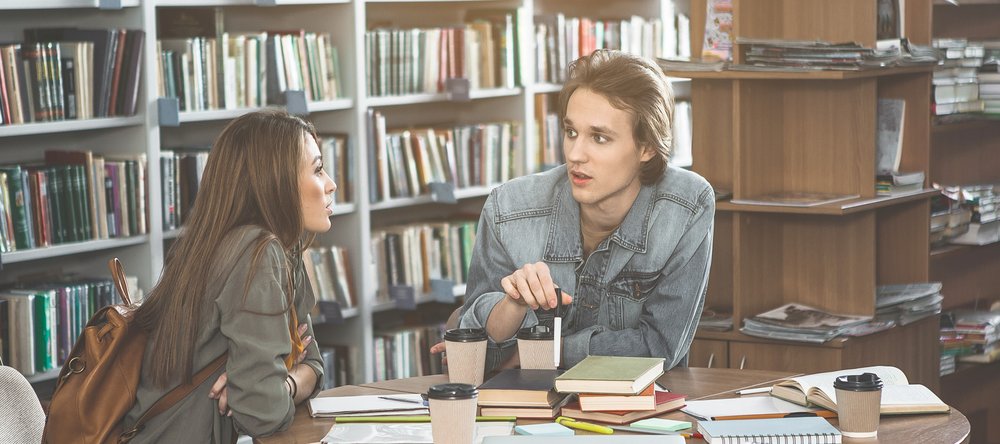 a couple of students in a library